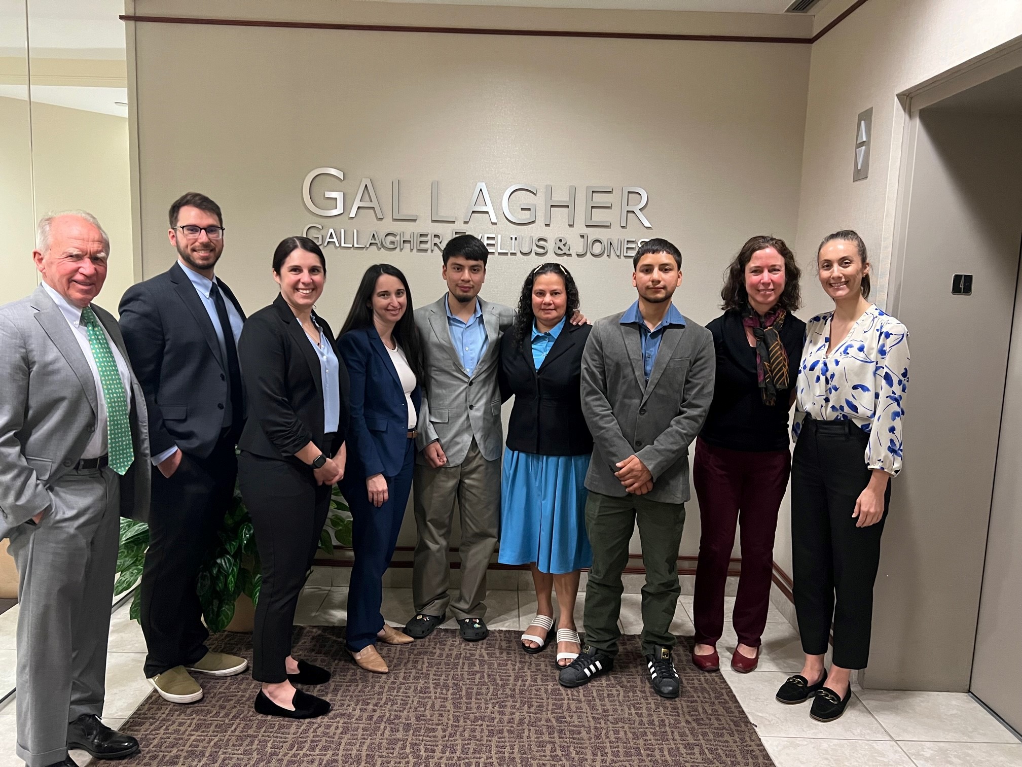 This is a group photo of the woman whom Gallagher attorneys helped with her asylum case.
